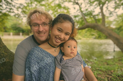 Preview: Multi-ethnic young family bonding together at the park