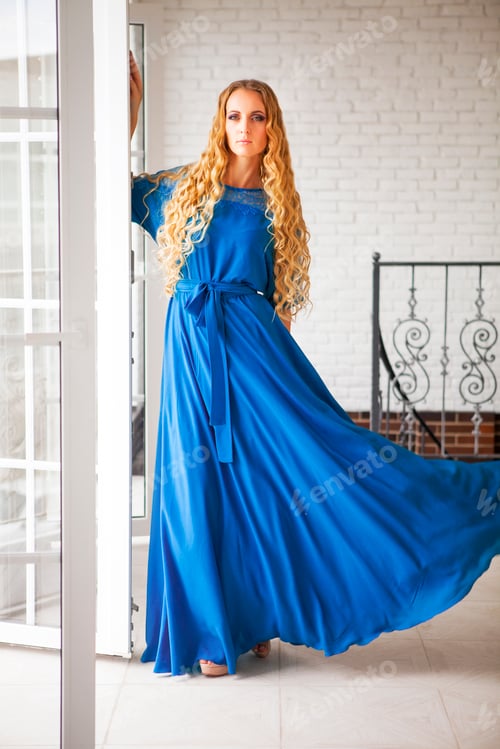 Preview: Beautiful blond woman in long dress near the stairs