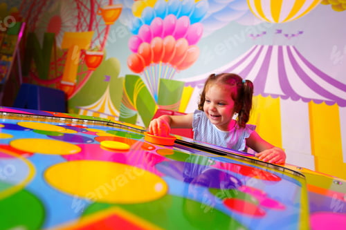 Preview: Young Girl Engaging in Colorful Board Game Fun at a Vibrant Playroom