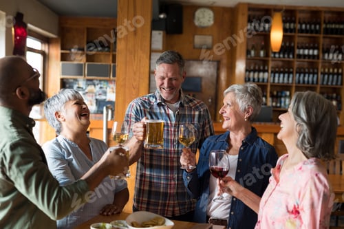 Preview: Happy friends having drinks in bar