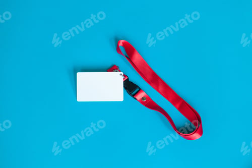 Preview: White plastic badge, red Lanyard with blank space mock up isolated on blue background