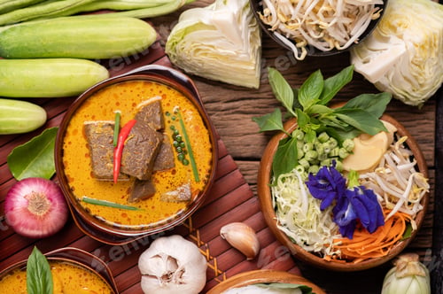 Preview: Rice noodles in a bowl of curry paste with chili, cucumber, long bean, lime, garlic and spring onion