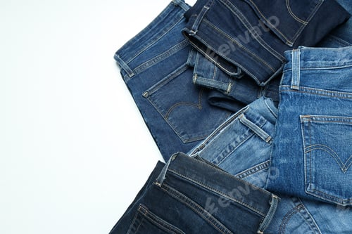 Preview: Ukraine, Kyiv, 08.10.2023 Folded jeans on a white background