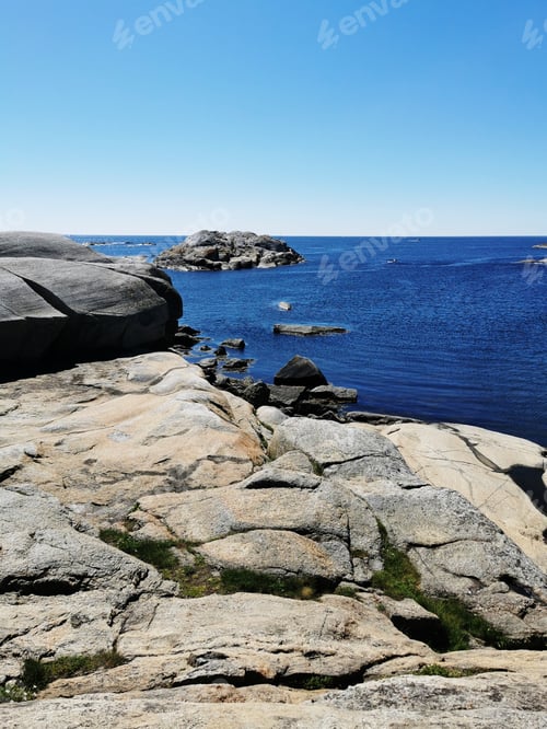 Preview: Scenic shot of a sea surrounded by stone mountains in Verdens Ende, Norway