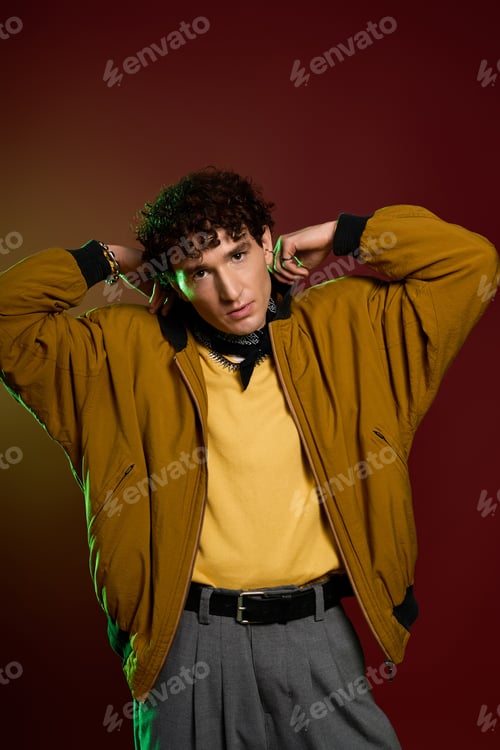 Preview: Sophisticated man showcasing modern fashion with confident pose in studio setting