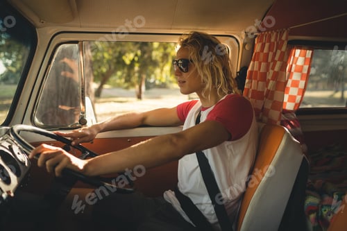 Preview: Side view of man driving camper van