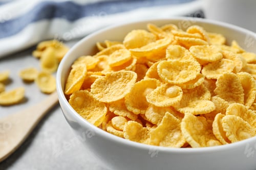 Preview: Tasty corn flakes on light grey table, closeup