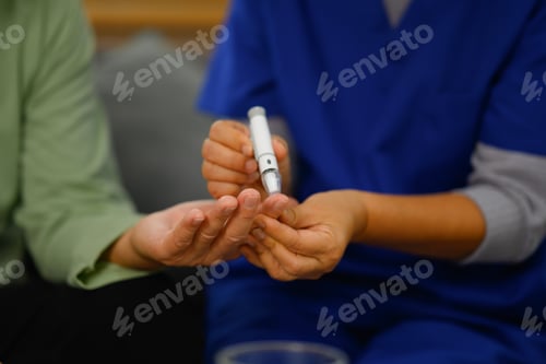 Preview: Unrecognizable female nurse checking blood sugar of diabetic elderly patient