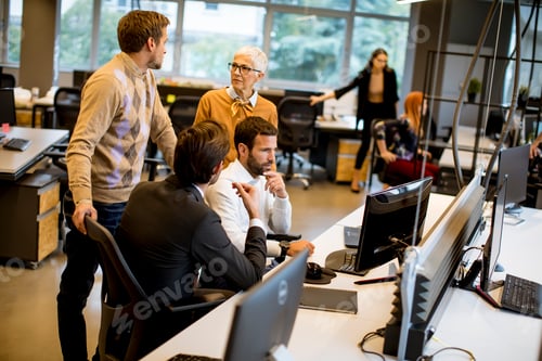 Preview: Senior businesswoman and young business people work in a modern office