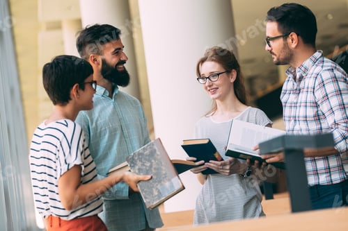 Preview: Group of students discussing in university library