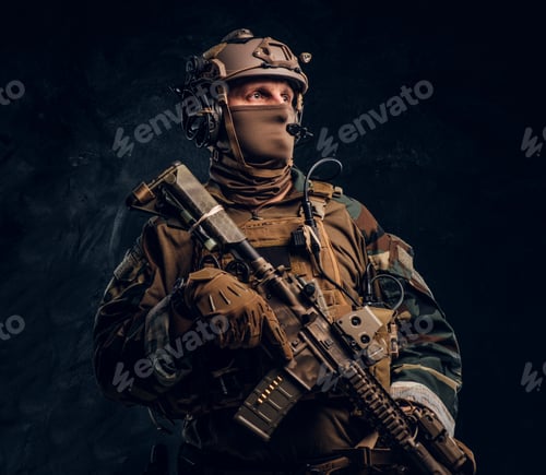 Preview: Elite unit, special forces soldier in camouflage uniform posing with assault rifle.