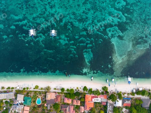 Preview: a beach area with several boats in the water and people on shore: Mapascua Island, Philippines