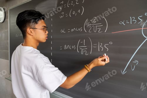 Preview: Teen asian high school boy student solving maths exercise on blackboard with chalk.