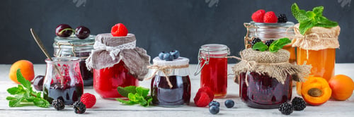 Preview: Assortment of seasonal berries and fruits jams in jars