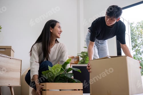 Preview: Young Couple Moving into New House, Unpacking Boxes and Plants, Starting a New Chapter Together in