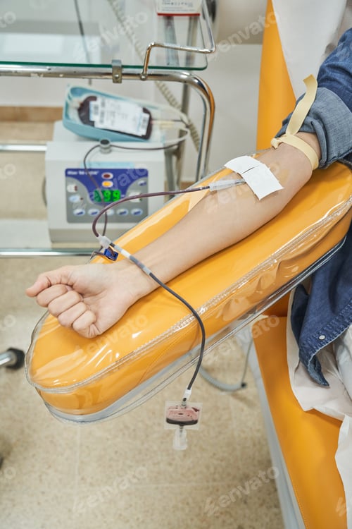 Preview: Unrecognizable female patient donating blood in clinic