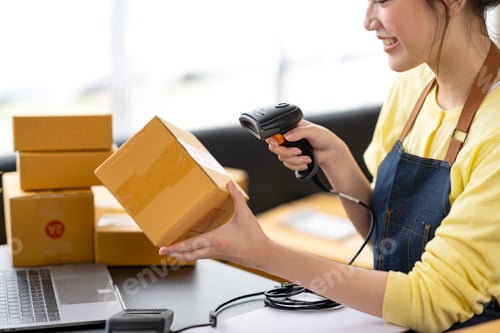 Preview: Startup happy Asian woman business owner works with a box at home, prepare parcel delivery SME suppl