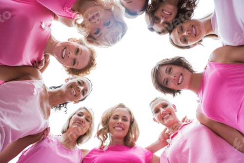 Preview: Happy Women Smiling In Circle Wearing Pink For Breast Cancer On White Background