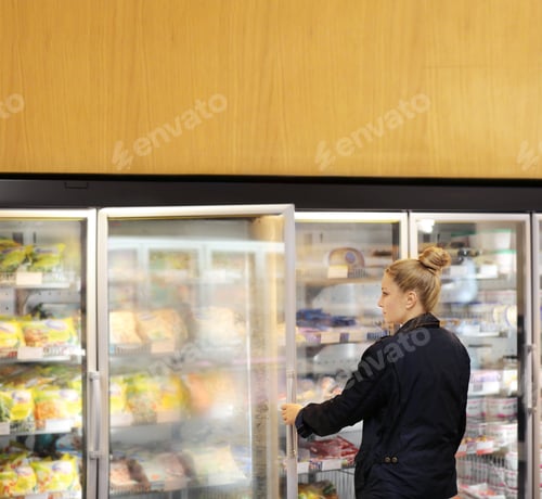 Preview: Woman Choosing Frozen Food From A Supermarket Freezer