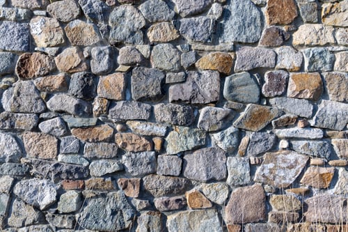 Preview: Background from a wall with stones in sunlight