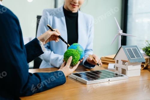 Preview: Two women analyze eco globe models, solar panels, and a smart home