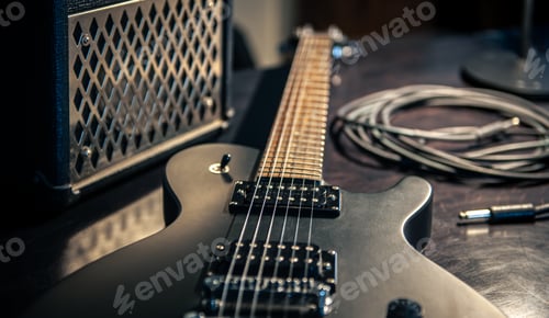 Preview: Close-up, black electric guitar on a dark background.