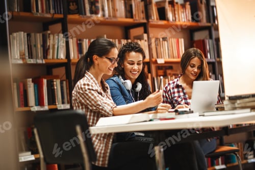 Preview: Group of female students study in the college library.
