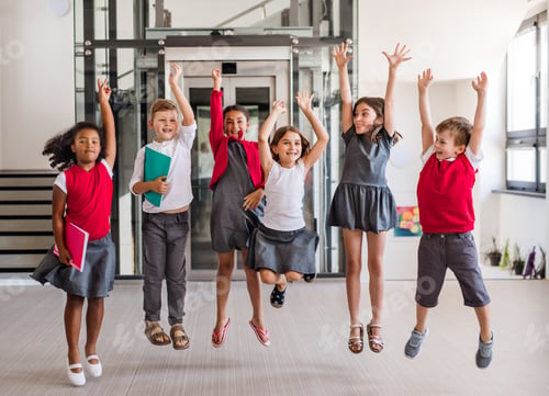 Preview: A group of cheerful small school kids in corridor, jumping