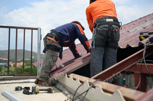 Preview: Professional engineer worker installing solar panels system on rooftop