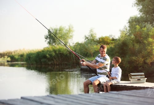 Preview: Dad and son fishing together on sunny day
