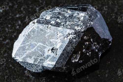 Preview: raw melanite andradite garnet crystal on black