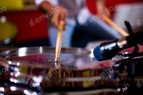 Preview: indian man playing the drums sticks close-up in recording studio