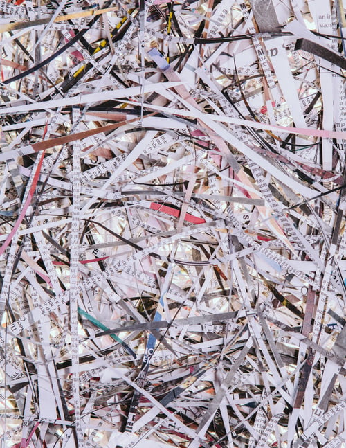 Preview: A pile of long thin shredded pieces of printed newspapers.