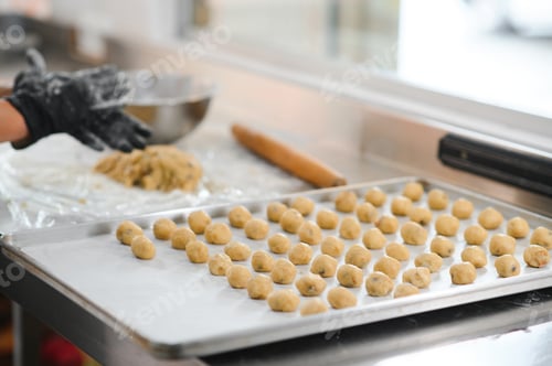 Preview: Raw homemade cookies in the shape of heart on a baking sheet for baking.