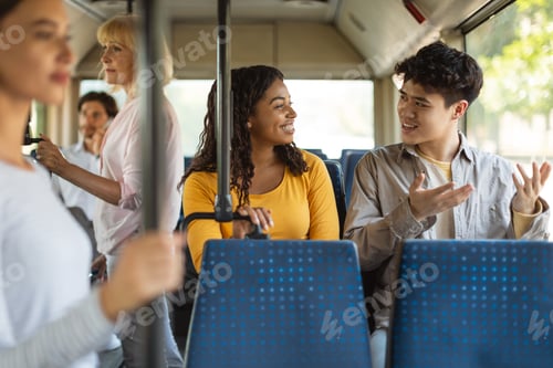 Preview: Happy young multiciltural friends taking bus together
