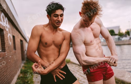 Preview: Attractive young body builders posing outdoors