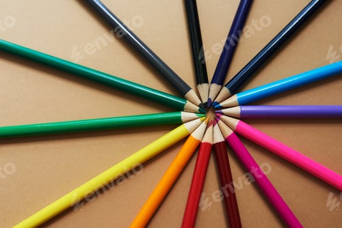 Preview: Studio shot of different coloured pencils against a brown background