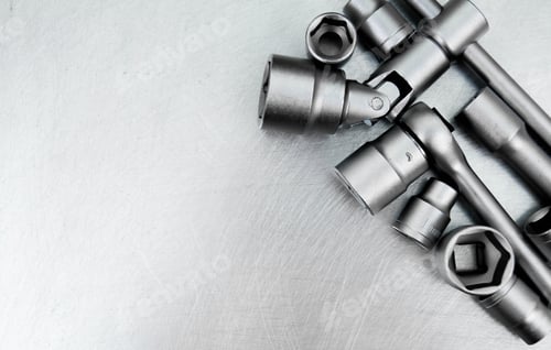 Preview: Wrench with a set of heads on the scratched metal background.
