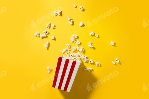 Preview: Classic striped bucket with delicious popcorn on yellow background