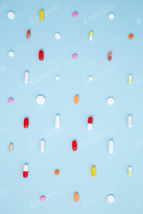 Preview: Various white medication tablets and capsules on blue background. Concept of healthcare and medicine