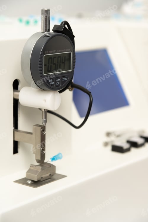 Preview: Vertical closeup shot of equipment in a medical laboratory for manufacturing medical syringes