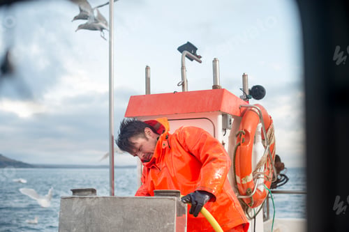 Preview: Fisherman cleaning fishing boat