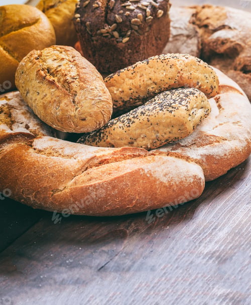 Preview: Bread loaves variety on wood. Traditional bakery concept.