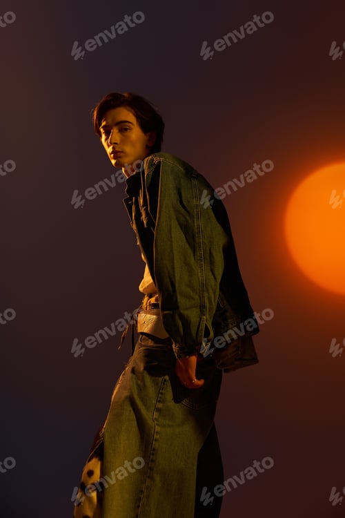 Preview: Fashionable non binary figure poses with a sunset backdrop showcasing pride and style