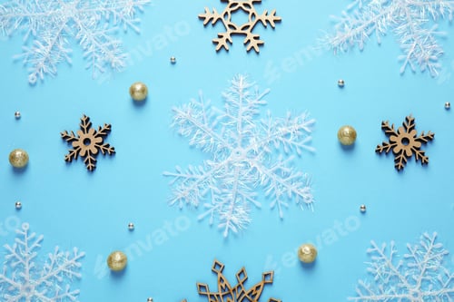 Preview: Flat lay composition with Christmas balls and snowflakes on blue background