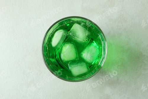Preview: Glass of green soda on white textured background