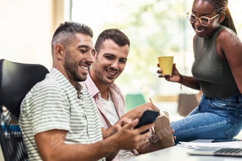 Preview: Successful business team working together with computer while talking and looking smartphone