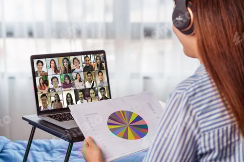 Preview: Rear view of Asian woman working and online meeting via video conference with colleague
