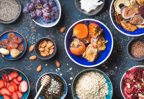 Preview: Ingredients in bowls for healthy breakfast over dark blue background
