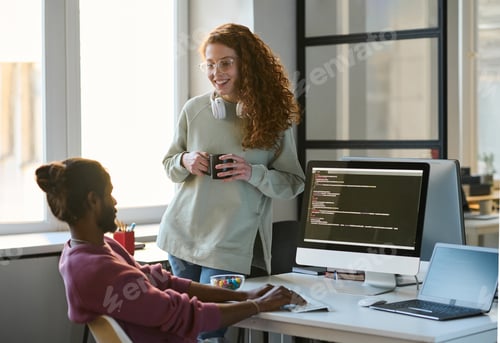 Preview: Woman talking to her colleague during coffee break